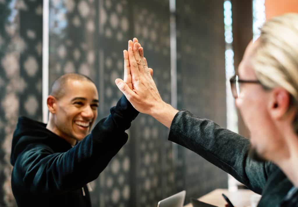A Man and a woman high fiving.