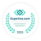 A circular badge displaying "Expertise.com Best Acupuncturists in Hackensack, NJ 2022" with decorative laurel branches and geometric logo.