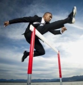 Epidemic Marketing Man in Suit Jumping over Hurdles