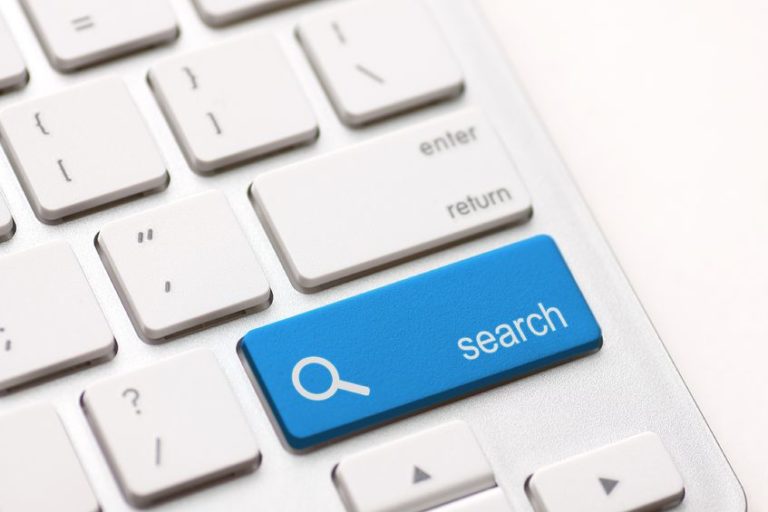 If you don't know searcher intent you are missing out on opportunities to meet your customers. White keyboard with a blue search button illustrates the importance of knowing what the searcher is looking for.