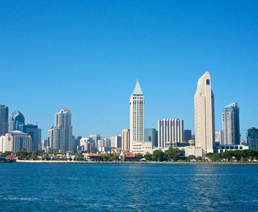 Several buildings near the ocean forming a skyline