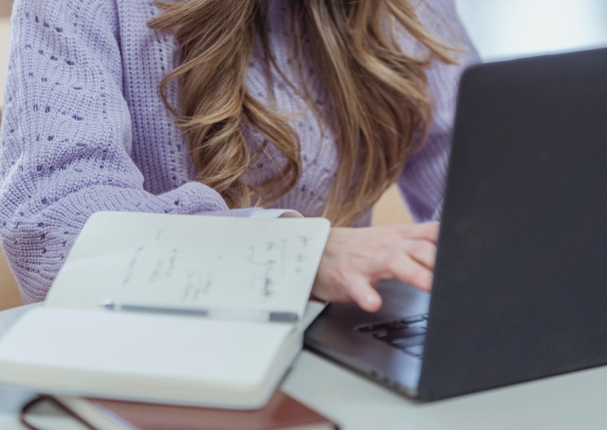 woman writing a blog post in her laptop